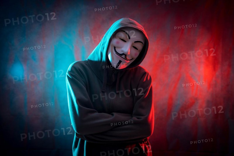 Hacker with anonymous mask with arms crossed
