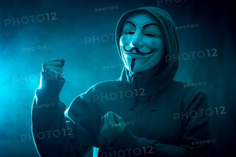 Hacker with anonymous mask with a making fight symbol