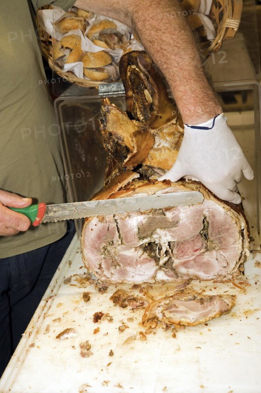 A man cuts a slice from a stuffed