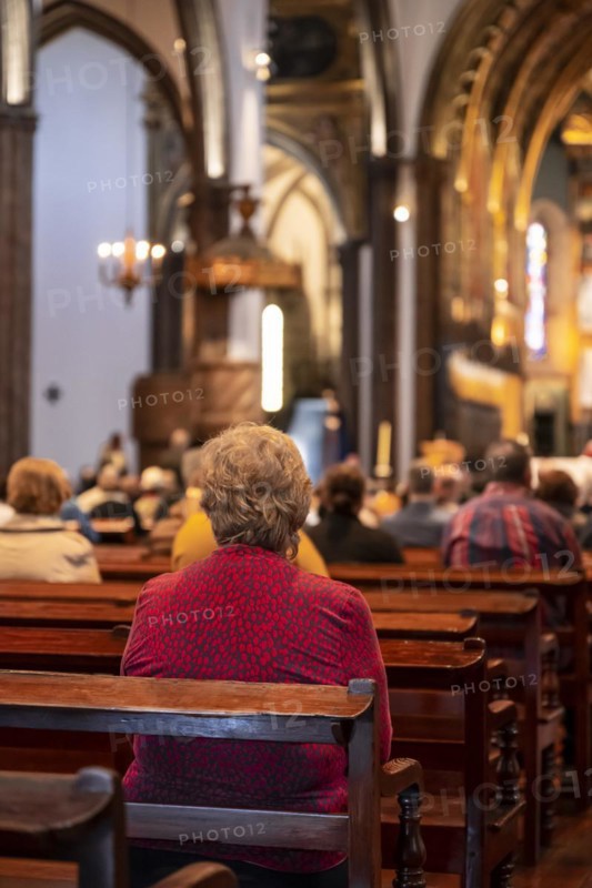 Faithful old lady in the church