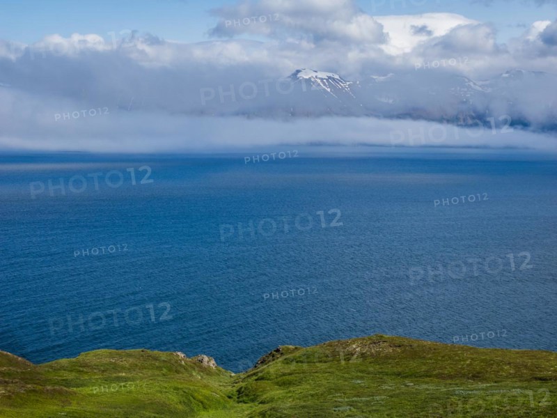 View over Eyjafoerour to the snow-capped mountains near Dalvik