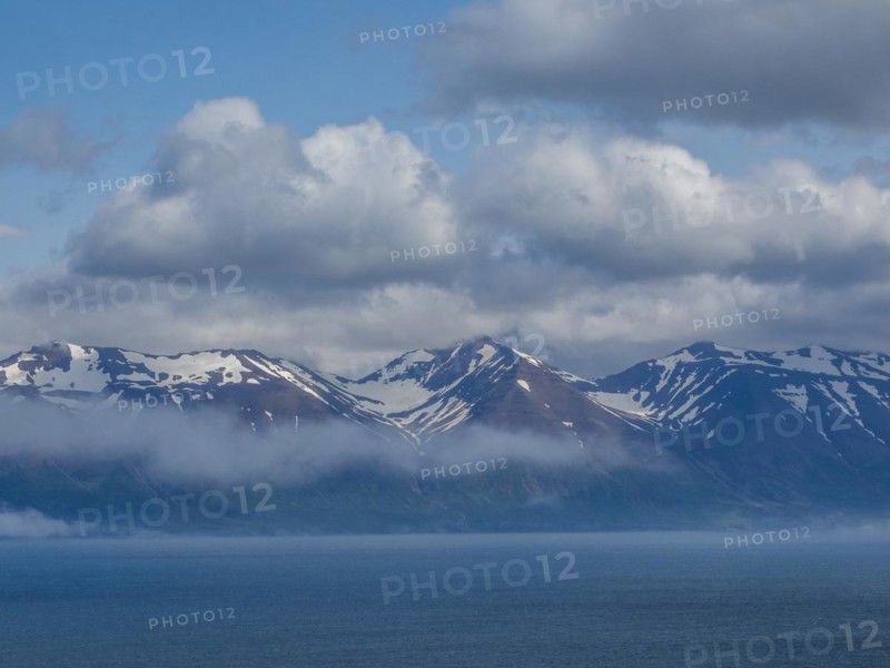 View over Eyjafoerour to the snow-capped mountains near Dalvik