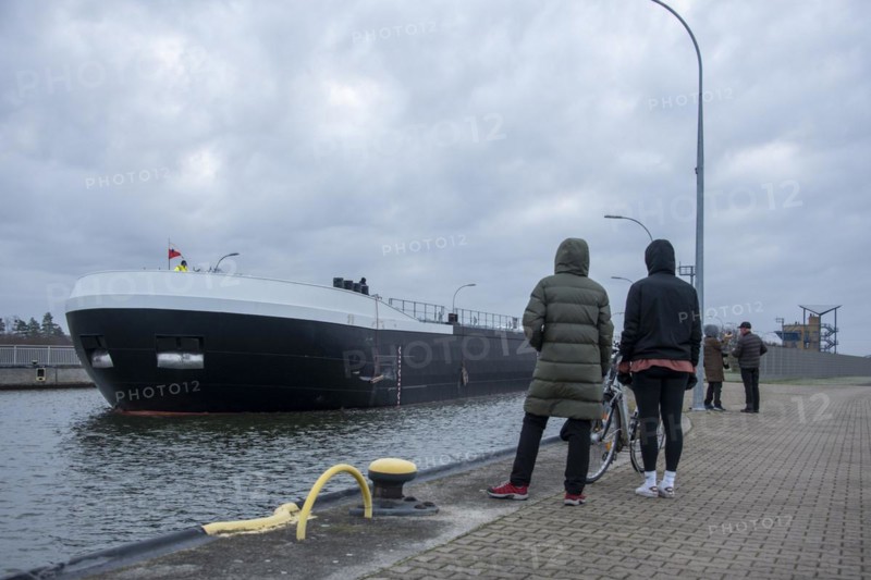 Onlookers look at a newly built tanker