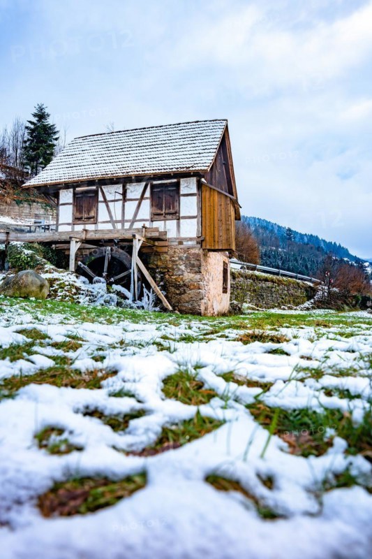 Water mill in snow and ice in winter