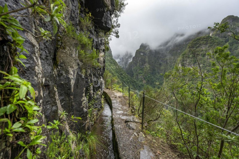 Narrow hiking trail along a levada