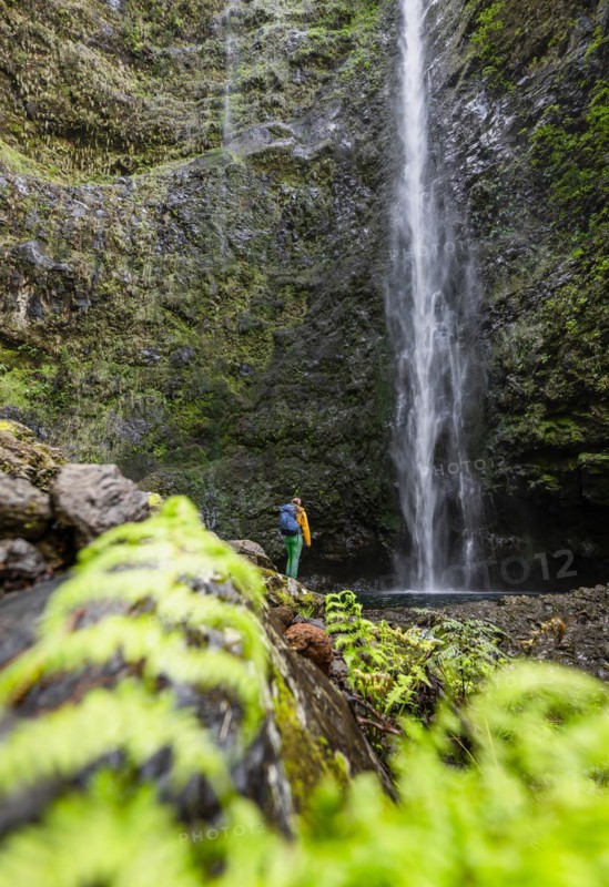 Hiker at the Caldeirao Verde waterfall on PR9 Levada do Caldeirao Verde