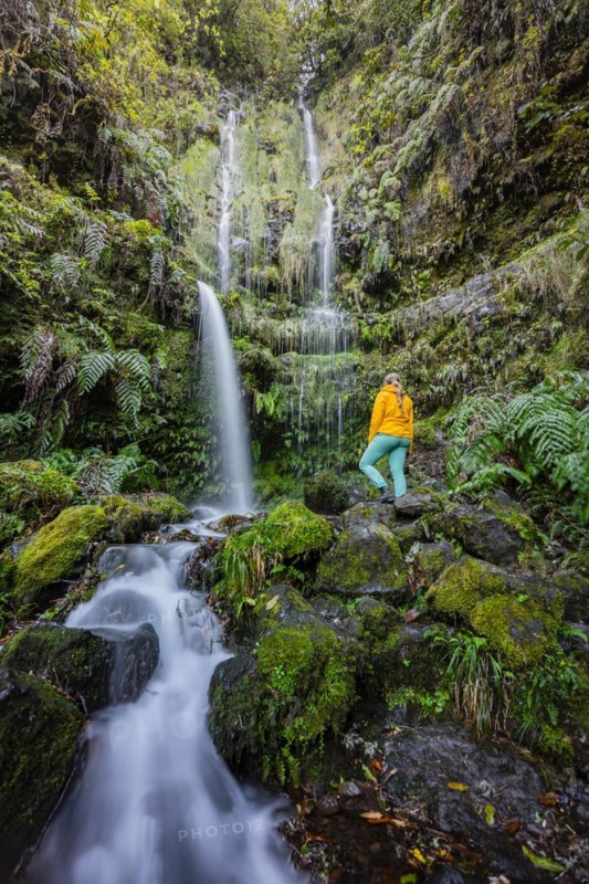 Hiker in front of waterfall