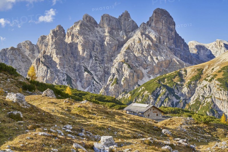 Alpine hut with mountain panorama in autumn
