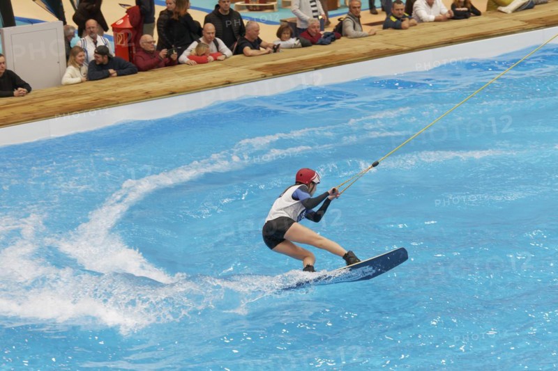 Wakeboarder glides over water