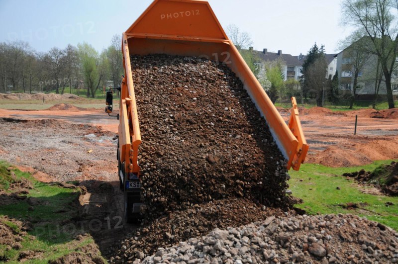 Truck dumps stones and building rubble