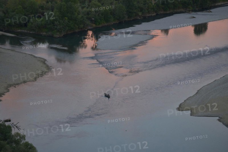 Fishing boat at the confluence of the rivers Buna and Drin with sunset