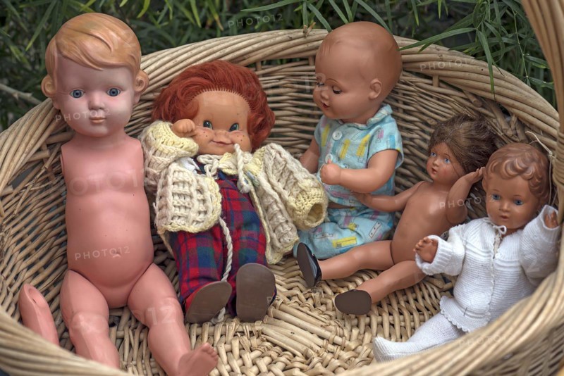 Antique baby dolls in a basket