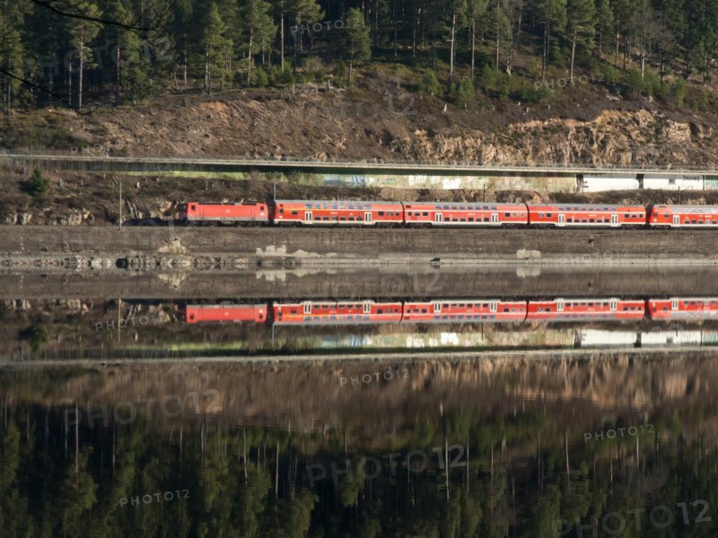 Reflection of a red train on the shore of Schluchsee