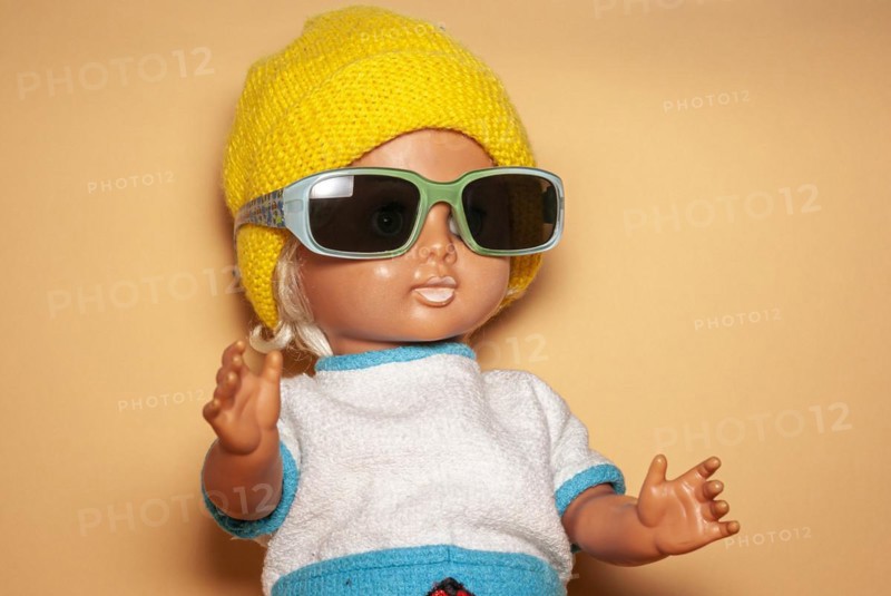 Cool doll with sunglasses and yellow knitted cap