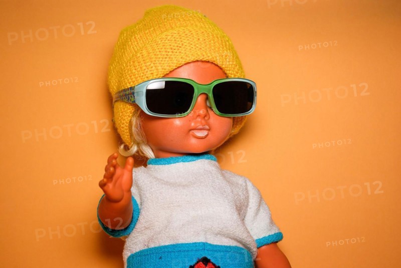 Cool doll with sunglasses and yellow knitted cap