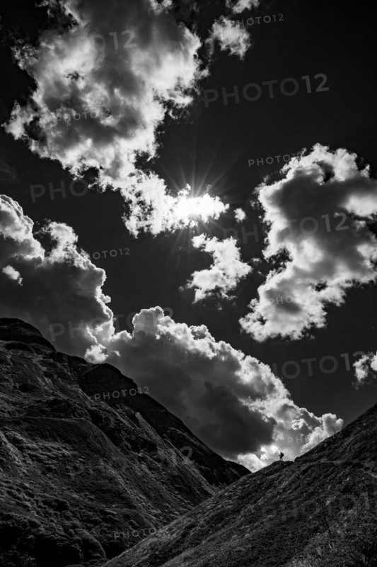 Mountain path with climber in Val Belver with cloudy sky