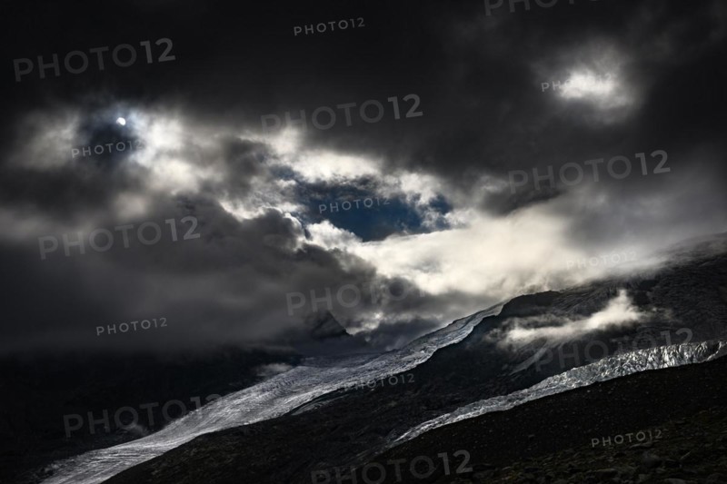 Bernina Group with Rosegg Glacier and dramatic clouds at blue hour