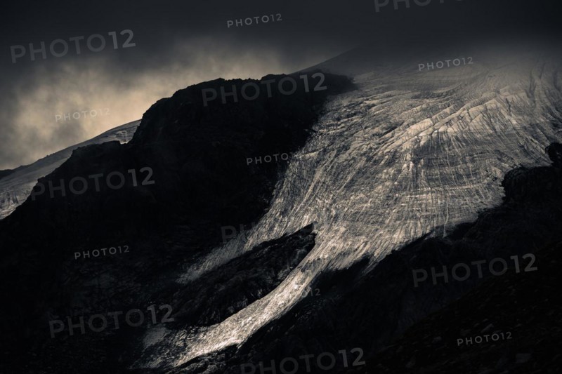 Bernina Group with Rosegg Glacier and dramatic clouds at blue hour