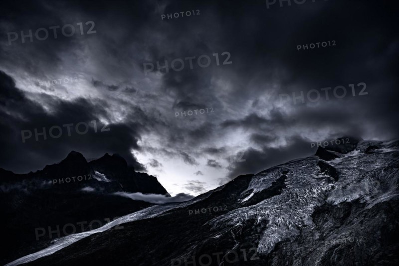 Bernina Group with Rosegg Glacier and dramatic clouds at blue hour