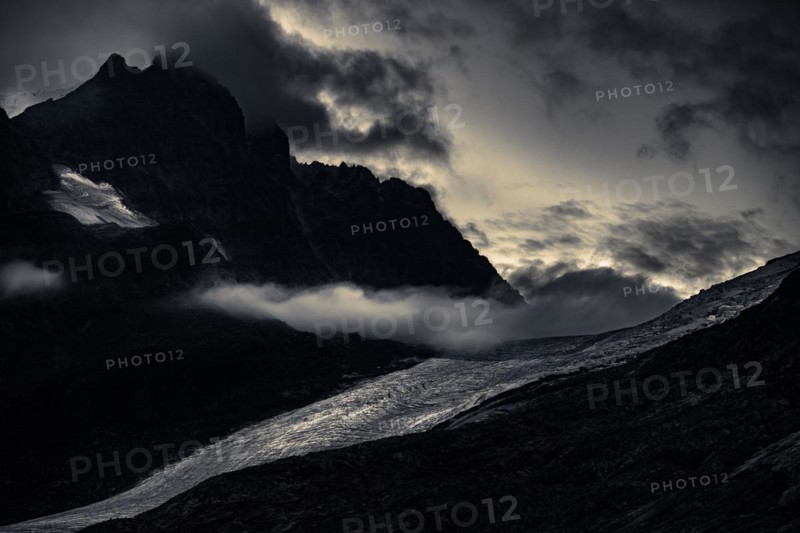 Bernina Group with Rosegg Glacier and dramatic clouds at blue hour