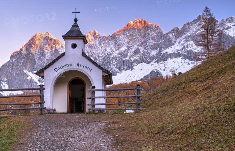 Chapel in front of mountain panorama in autumn