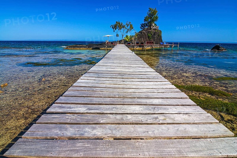 Pier to little islet on the coastline of the Island Ile Sainte Marie