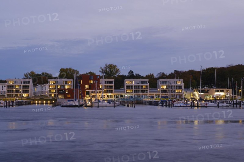 Marina and illuminated modern buildings at Priwall