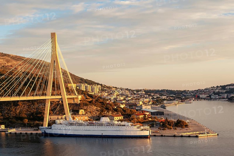 Sunset over Dubrovnik with bridge and cruise ship