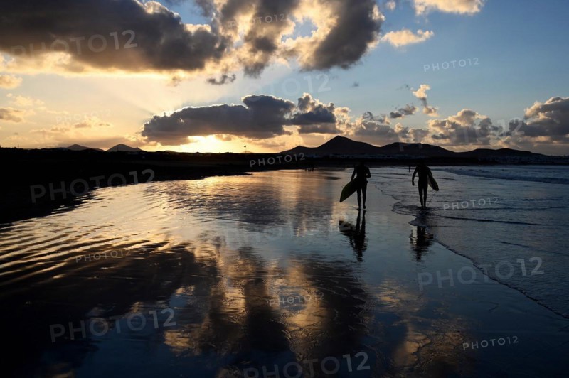 Surfers on the beach of Caleta de Famara