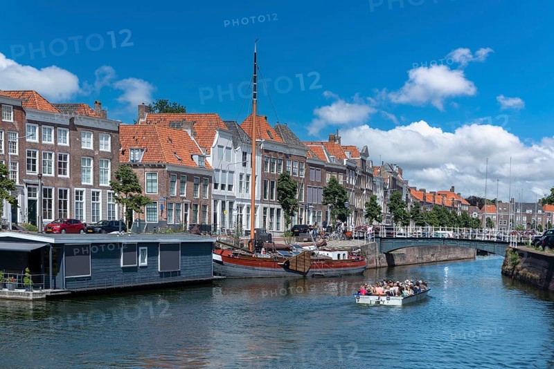 Cityscape with houseboat and traditional flat-bottomed sailing boat at Bierkaai