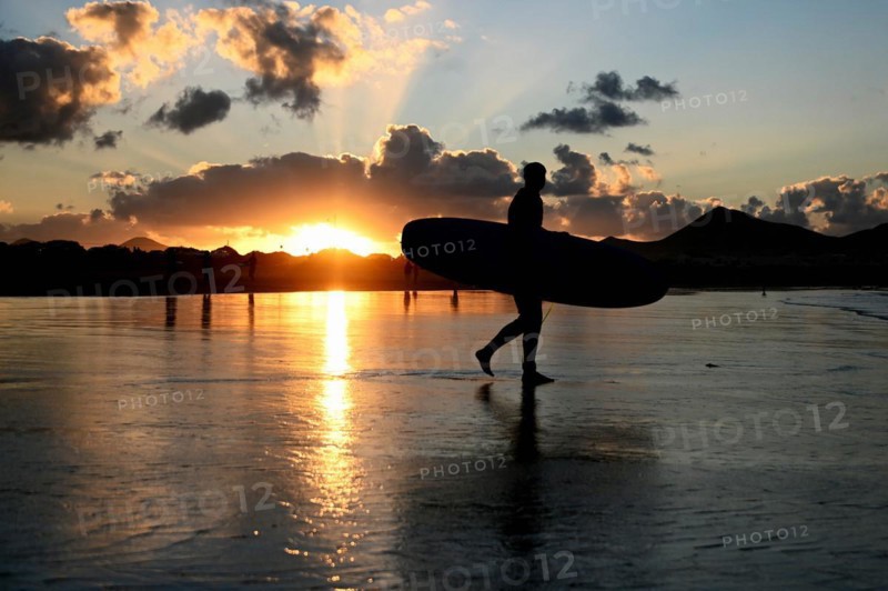 Surfers on the beach of Caleta de Famara