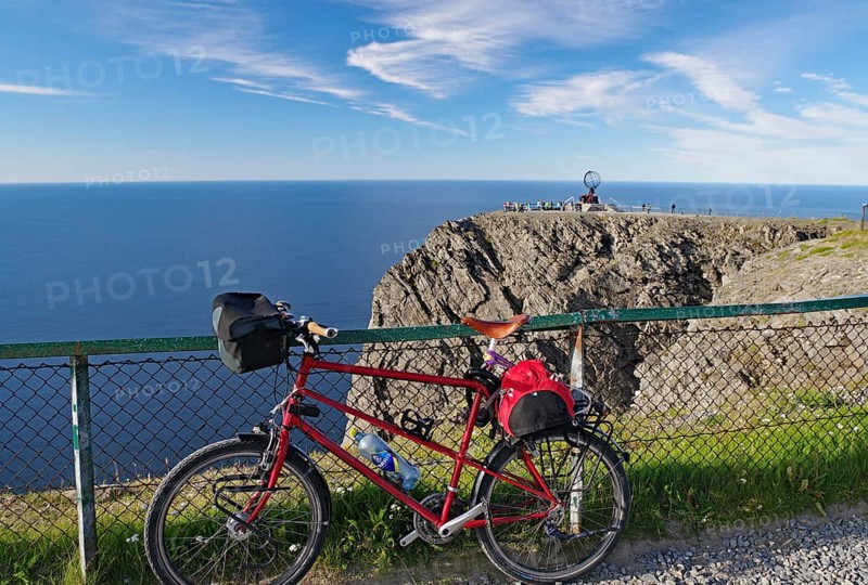 Mountain bike leaning against a fence