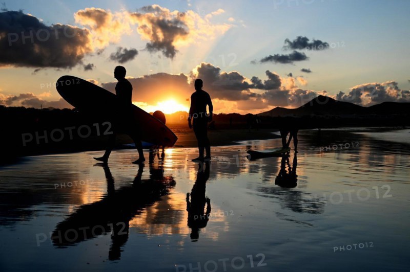 Surfers on the beach of Caleta de Famara