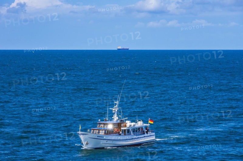 The motor yacht Merkur II returns from a burial at sea and enters the home port of Rostock-Warnemuende