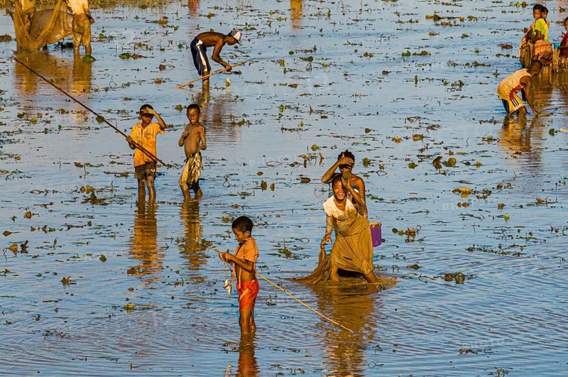 Locals fishing in a shallow lake