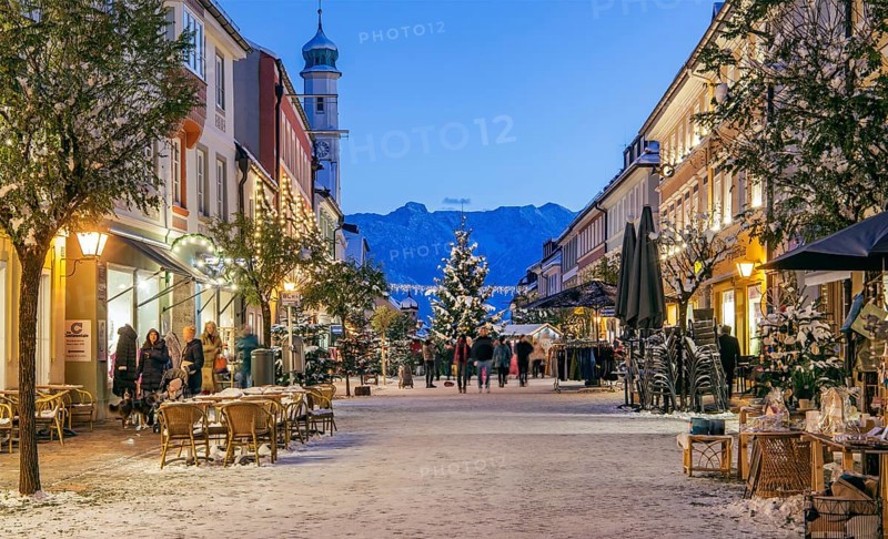 Winter Obermarkt in the snow with Christmas tree and Christmas lights in front of the Hoehen Kiste 1922m in the Estergebirge