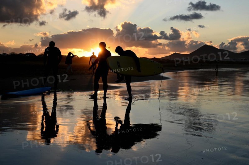 Surfers on the beach of Caleta de Famara