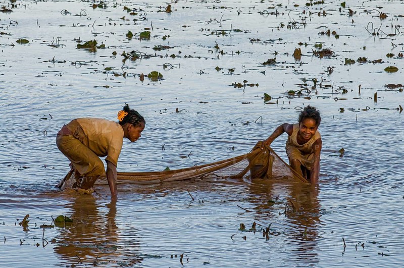 Locals fishing in a shallow lake