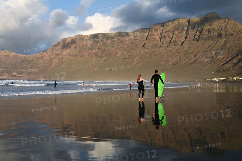 Surfers on the beach of Caleta de Famara