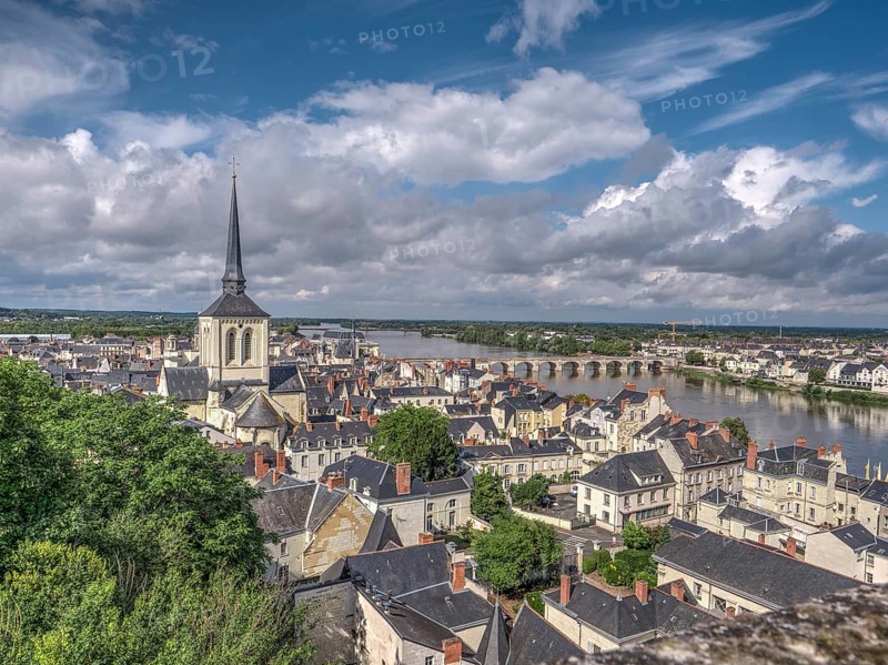 Panorama of the town of Saumur with the dominating bell tower of the Eglise Saint-Pierre-du-Marais and the Loire with the old bridge Pont Cessart