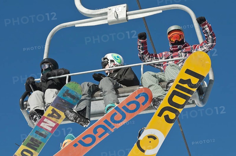 Snowboarders on a ski lift