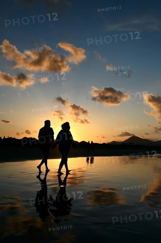 Sunset reflected on Caleta de Famara beach
