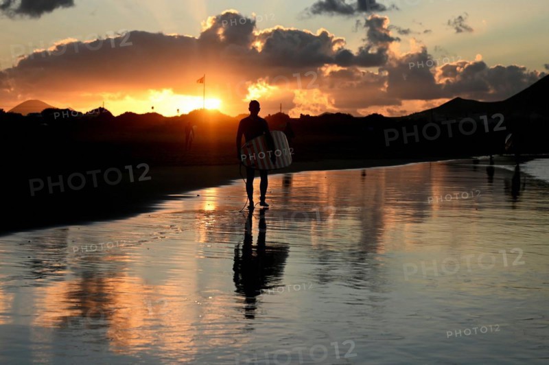 Surfers on the beach of Caleta de Famara