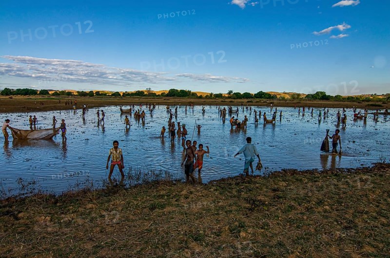 Locals fishing in a shallow lake