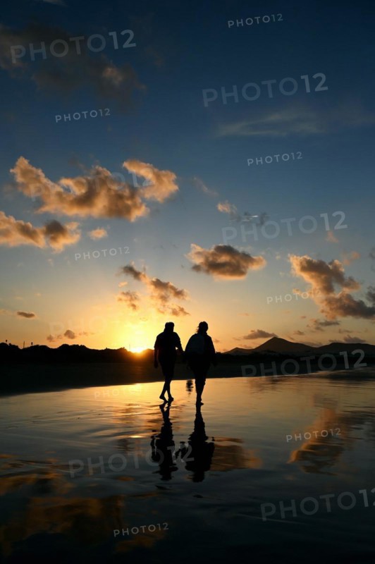 Sunset reflected on Caleta de Famara beach