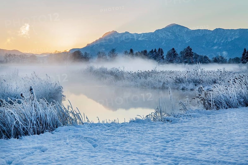 Snowy winter landscape with the Uffinger Ach at sunrise with Herzogstand 1731m and Heimgarten 1790m