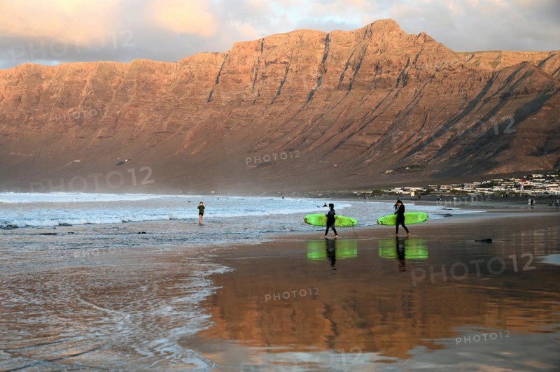 Surfers on the beach of Caleta de Famara