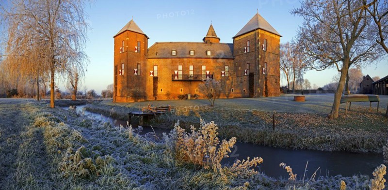 Water castle Haus Zelem with hoarfrost at sunrise