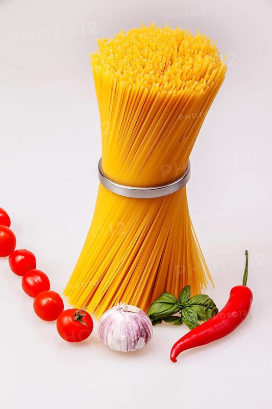 Spaghetti standing with fresh spices and vegetables