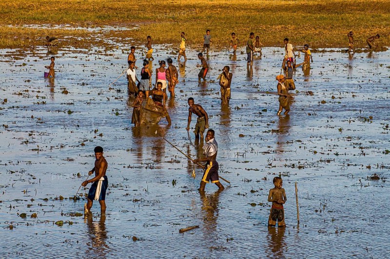 Locals fishing in a shallow lake